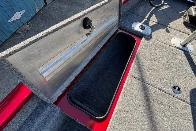 Slide: The Image of 2023 Tracker Pro Team 175 TF boat storage compartment with open lid, showcasing interior space. - 12