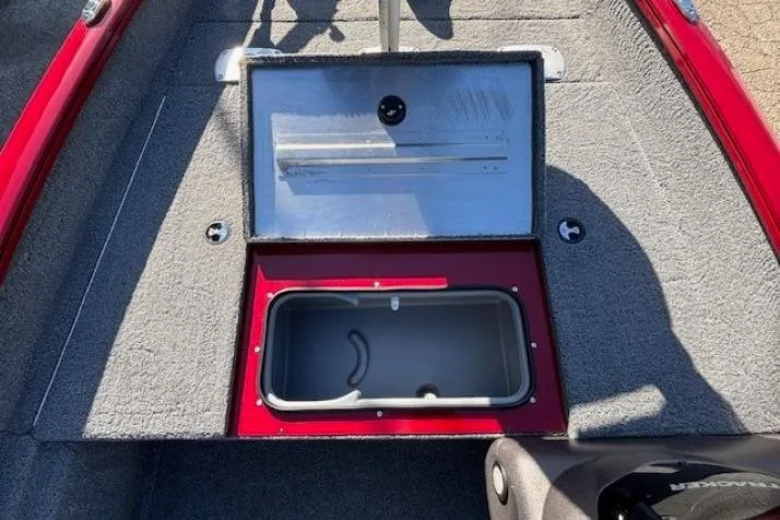 Slide: The Image of 2023 Tracker Pro Team 175 TF boat storage compartment with open lid, red and gray interior. - 14