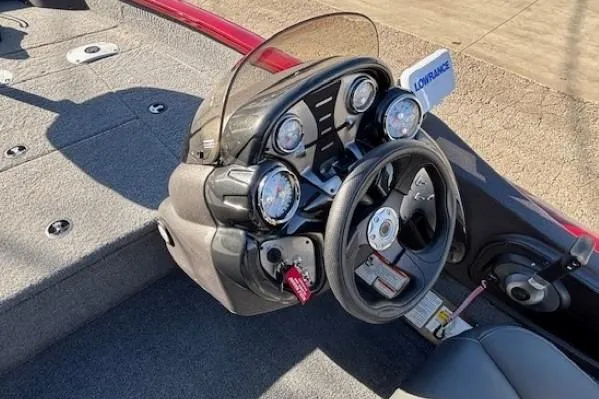 Slide: The Image of 2023 Tracker Pro Team 175 TF boat dashboard with steering wheel and gauges. - 16