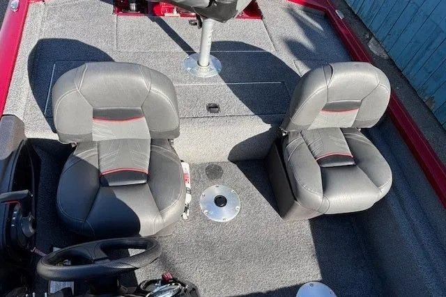 Slide: The Image of 2023 Tracker Pro Team 175 TF boat interior with gray seats and steering wheel. - 18