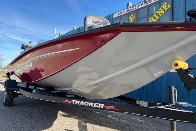 Slide: The Image of 2023 Tracker Pro Team 175 TF boat on trailer, red and white design, outdoor display. - 2