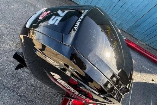 Slide: The Image of 2023 Tracker Pro Team 175 TF with Mercury 75 engine, parked on pavement. - 24