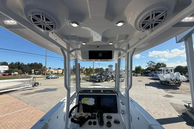 Slide: The Image of 2026 Crevalle 24 HCO boat interior with modern dashboard and overhead speakers. - 12