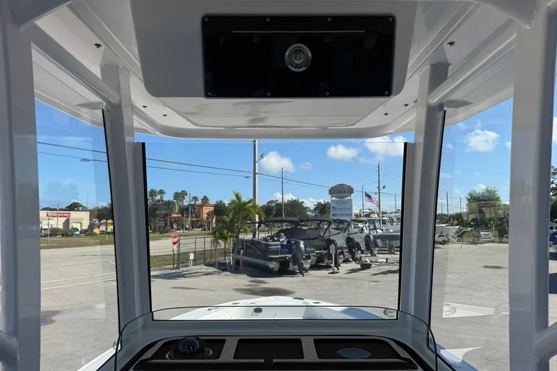 Slide: The Image of Interior view from a 2026 Crevalle 24 HCO boat, showcasing a marina and clear skies. - 13