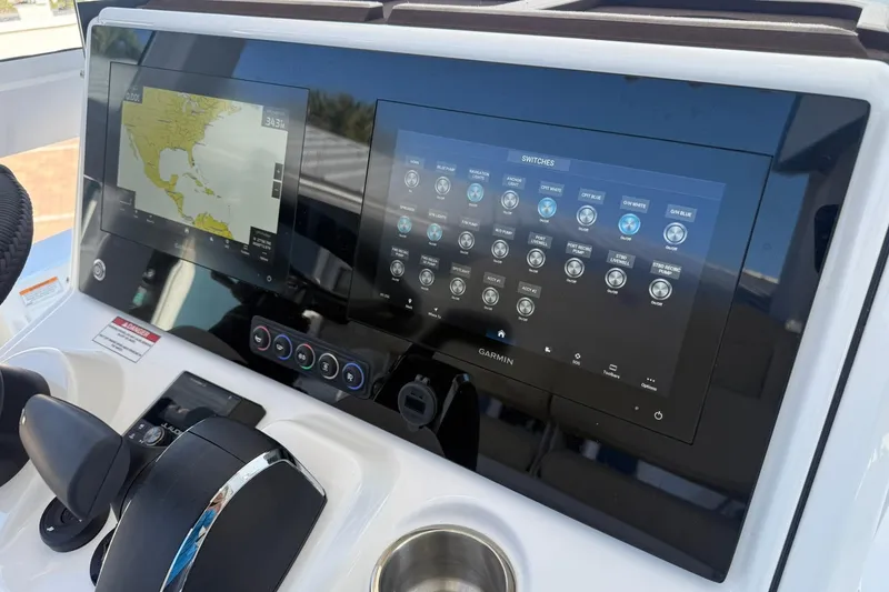 Slide: The Image of 2026 Crevalle 24 HCO boat dashboard with Garmin navigation and control screens. - 15