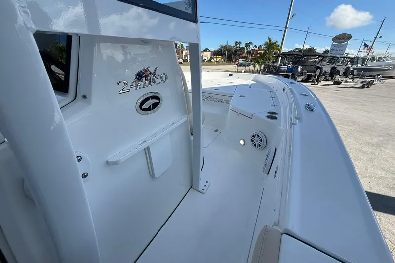 Slide: The Image of 2026 Crevalle 24 HCO boat, sleek white design, docked outdoors under blue sky. - 18