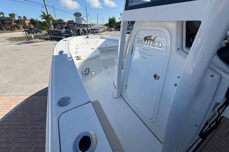 Slide: The Image of 2026 Crevalle 24 HCO boat, sleek design, docked outdoors under clear sky. - 19