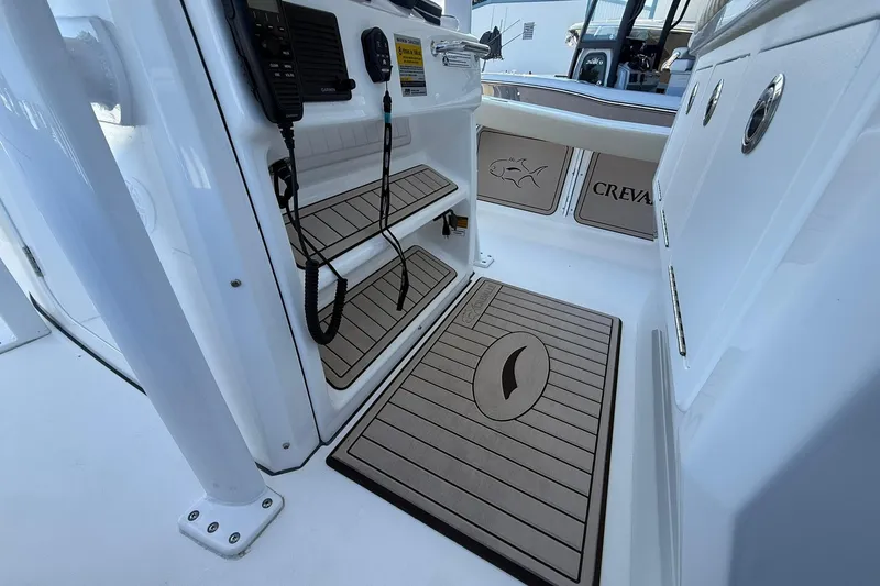 Slide: The Image of 2026 Crevalle 24 HCO boat interior with non-slip flooring and control panel. - 22
