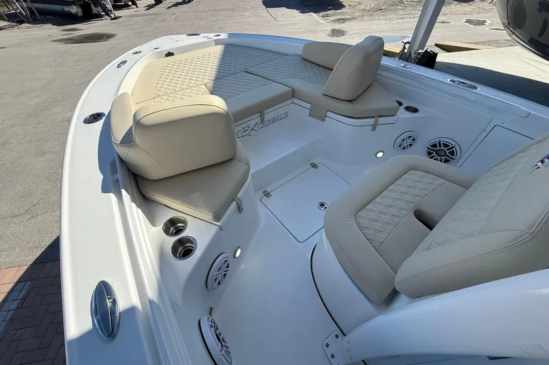Slide: The Image of 2026 Crevalle 24 HCO boat interior with beige seating and cup holders. - 27