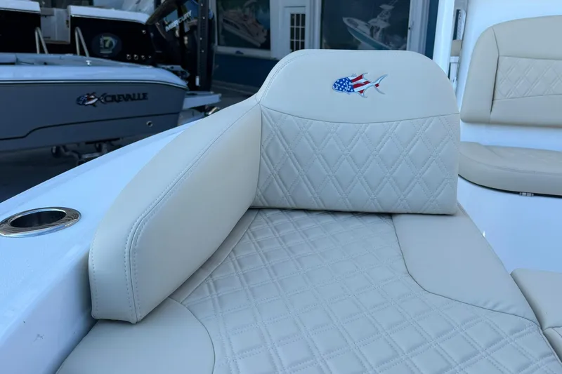 Slide: The Image of 2026 Crevalle 24 HCO boat interior with diamond-stitched seating and patriotic fish emblem. - 31