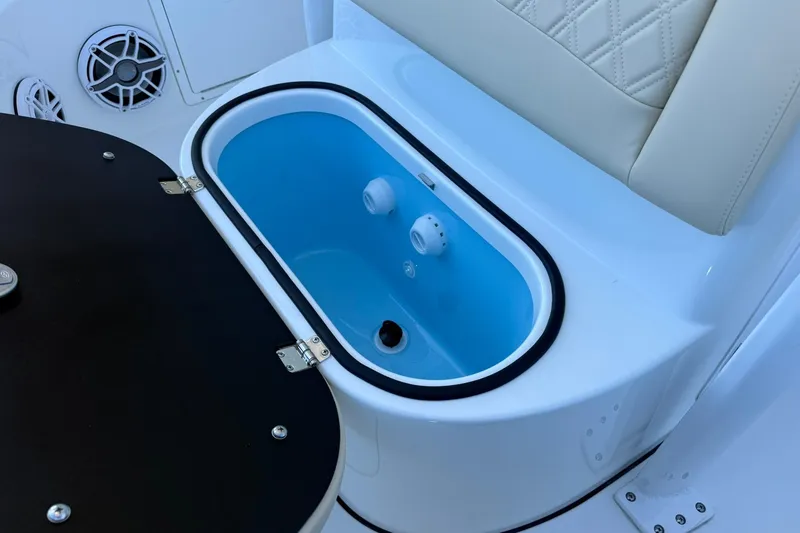 Slide: The Image of Livewell on 2026 Crevalle 24 HCO boat, featuring sleek design and seating. - 33