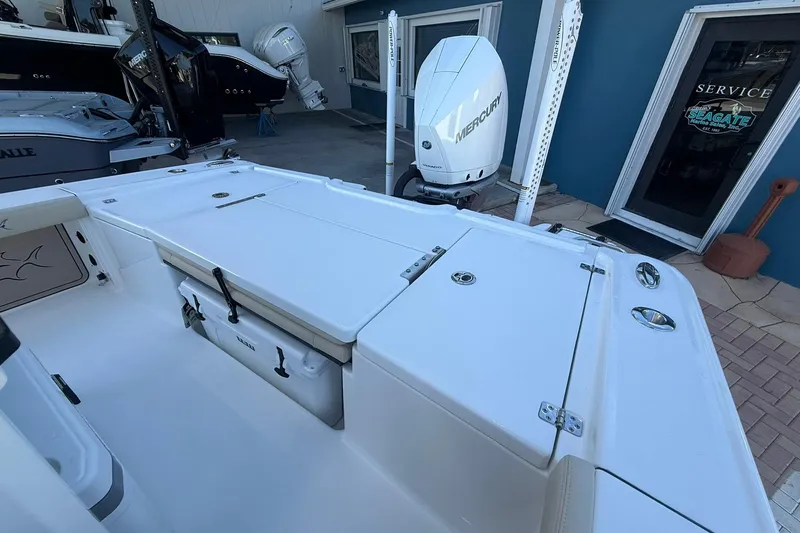 Slide: The Image of 2026 Crevalle 24 HCO boat with Mercury engine, docked near service area. - 5