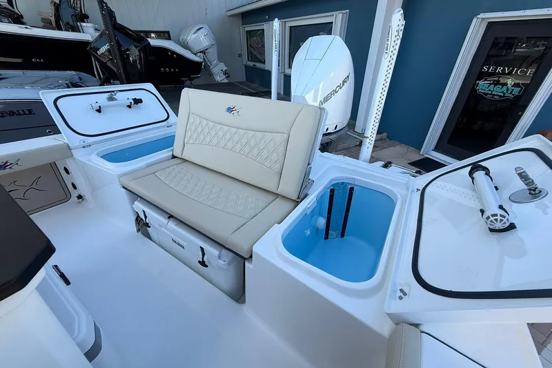 Slide: The Image of 2026 Crevalle 24 HCO boat interior with seating, storage, and Mercury engine. - 6