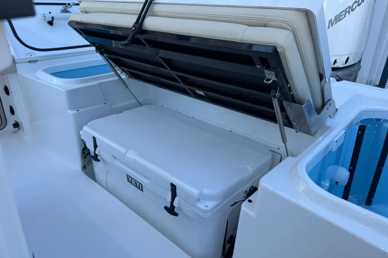 Slide: The Image of 2026 Crevalle 24 HCO boat interior with Yeti cooler and storage compartment. - 9