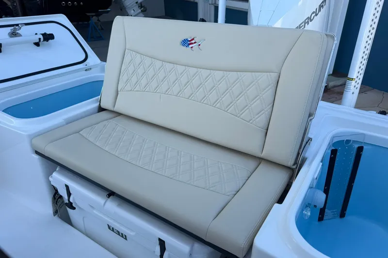 Slide: The Image of 2026 Crevalle 24 HCO boat seat with diamond stitching and integrated cooler. - 7
