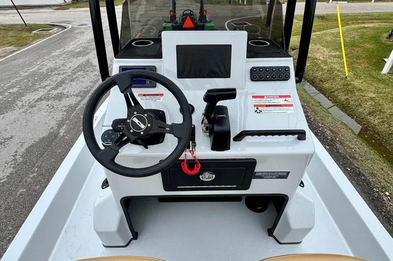 Slide: The Image of 2026 SCB R24 boat console with steering wheel and controls, parked on a road. - 12