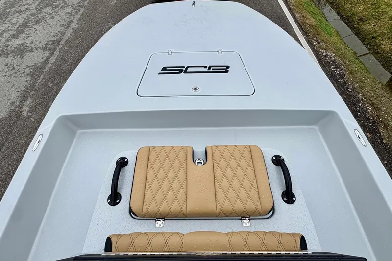 Slide: The Image of 2026 SCB R24 boat deck with tan diamond-stitched seating and SCB logo. - 14