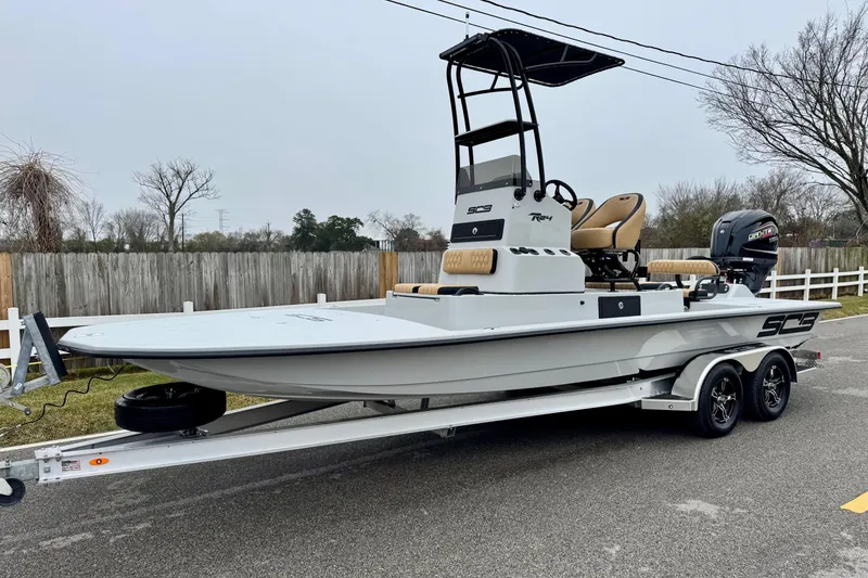 The Image of 2026 SCB R24 boat on trailer, sleek design, dual axles, outdoor setting. - 3