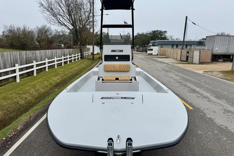 Slide: The Image of 2026 SCB R24 boat parked on a street. - 8