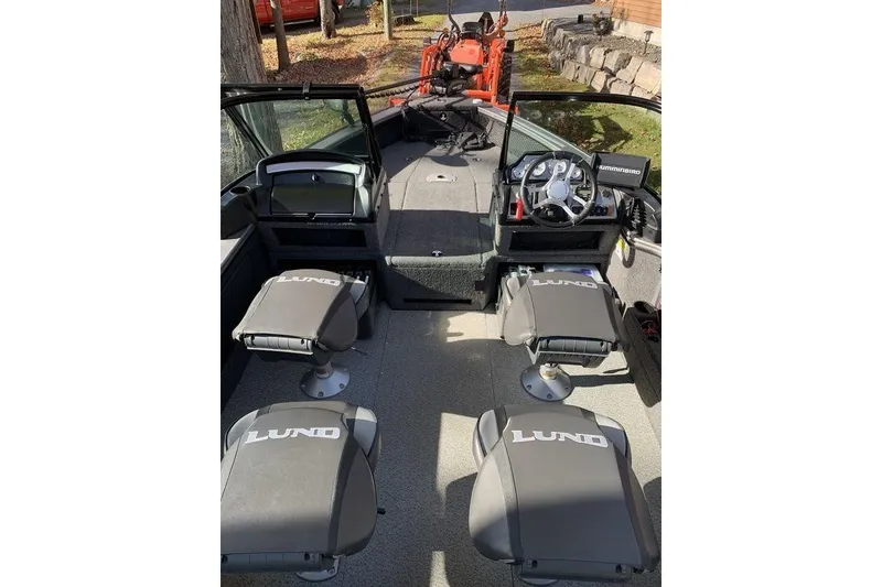 Slide: The Image of 2022 Lund 1875 Pro-V Sport boat interior with seating and steering console. - 8