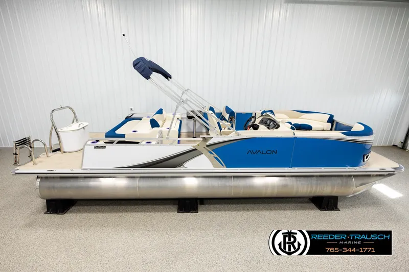 The Image of 2026 Avalon LSZ ENT pontoon boat in showroom, featuring blue and white design. - 1