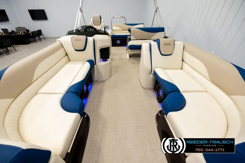 Slide: The Image of 2026 Avalon LSZ ENT pontoon boat interior with beige and blue seating. - 13