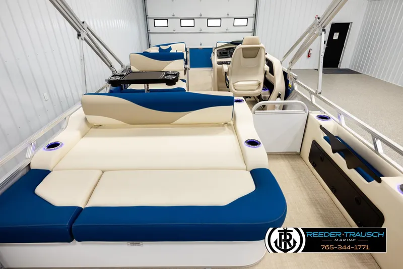 Slide: The Image of Luxurious 2026 Avalon LSZ ENT pontoon boat interior with blue and cream seating. - 16