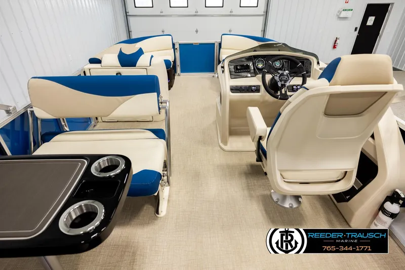 Slide: The Image of Interior of 2026 Avalon LSZ ENT pontoon boat with blue and beige seating and control panel. - 17