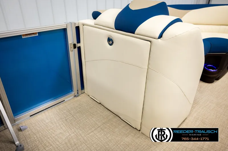 Slide: The Image of 2026 Avalon LSZ ENT boat interior with blue and cream seating, Reeder-Trausch Marine logo. - 20