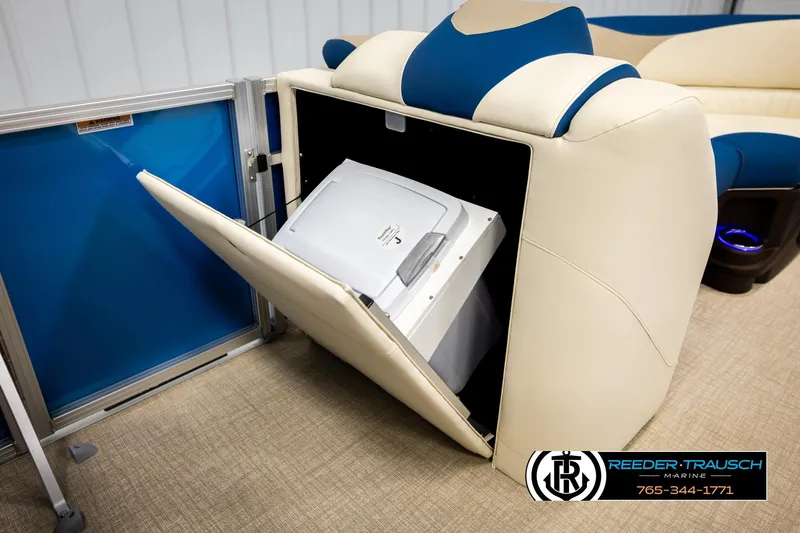 Slide: The Image of 2026 Avalon LSZ ENT boat with built-in cooler storage, beige and blue seating. - 21