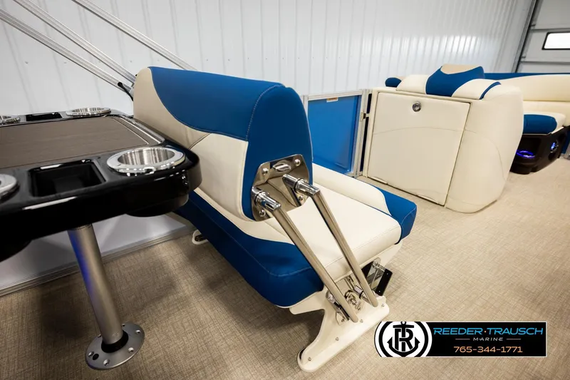 Slide: The Image of 2026 Avalon LSZ ENT boat interior with blue and white seating and table. - 24