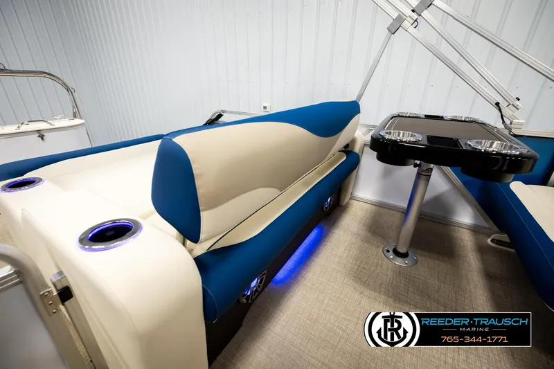 Slide: The Image of Luxurious interior of 2026 Avalon LSZ ENT pontoon boat with blue and beige seating. - 26