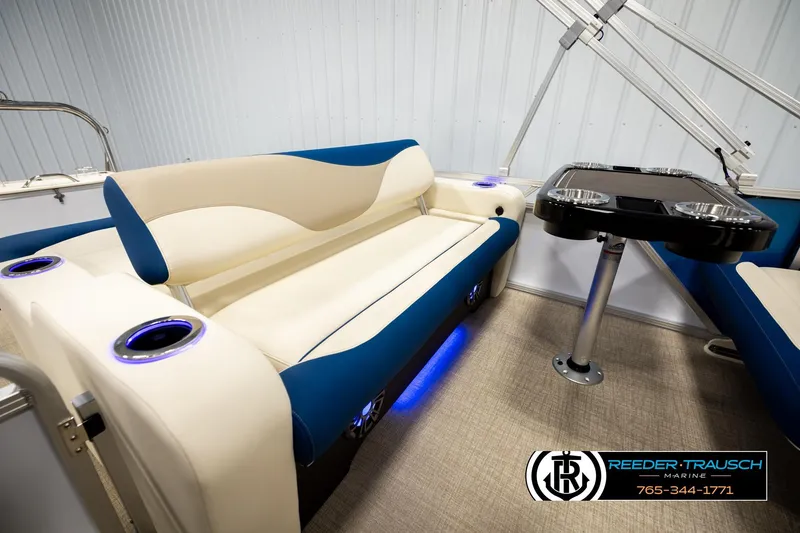 Slide: The Image of Luxurious seating area in 2026 Avalon LSZ ENT pontoon boat with table and cup holders. - 27
