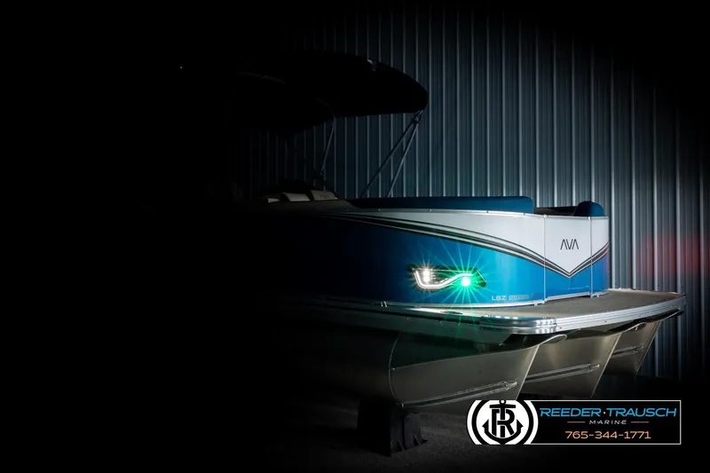 Slide: The Image of 2026 Avalon LSZ ENT pontoon boat with illuminated side light in a dimly lit setting. - 4