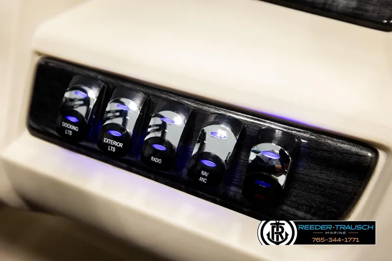 Slide: The Image of Control panel of 2026 Avalon LSZ ENT with illuminated switches for docking, exterior lights, and radio. - 42