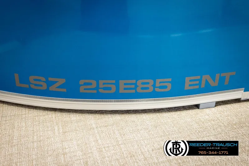 Slide: The Image of 2026 Avalon LSZ ENT boat with blue exterior and Reeder-Trausch Marine branding. - 52