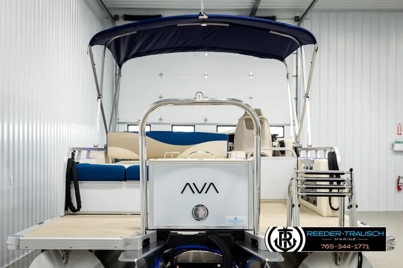 Slide: The Image of 2026 Avalon LSZ ENT pontoon boat in showroom, featuring blue canopy and beige seating. - 7