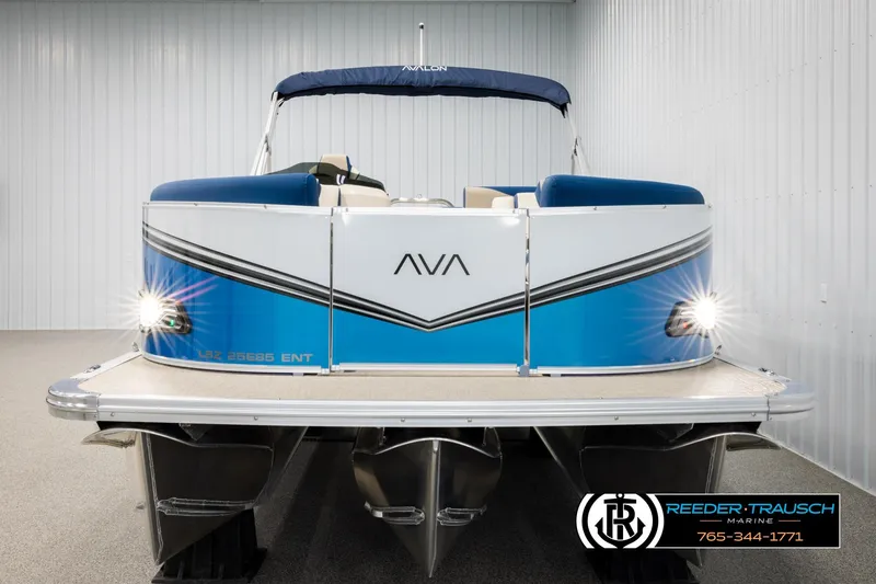 Slide: The Image of 2026 Avalon LSZ ENT pontoon boat with blue and white design in showroom. - 8