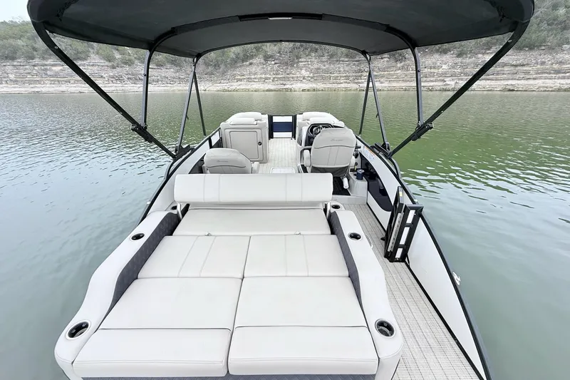 Slide: The Image of 2020 Barletta L23UC pontoon boat with spacious seating on a calm lake. - 12
