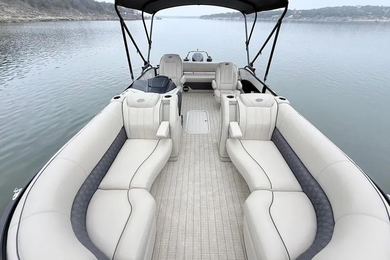 Slide: The Image of 2020 Barletta L23UC pontoon boat with luxurious seating on a calm lake. - 15