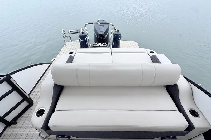 Slide: The Image of Luxurious seating on a 2020 Barletta L23UC pontoon boat, overlooking calm waters. - 17