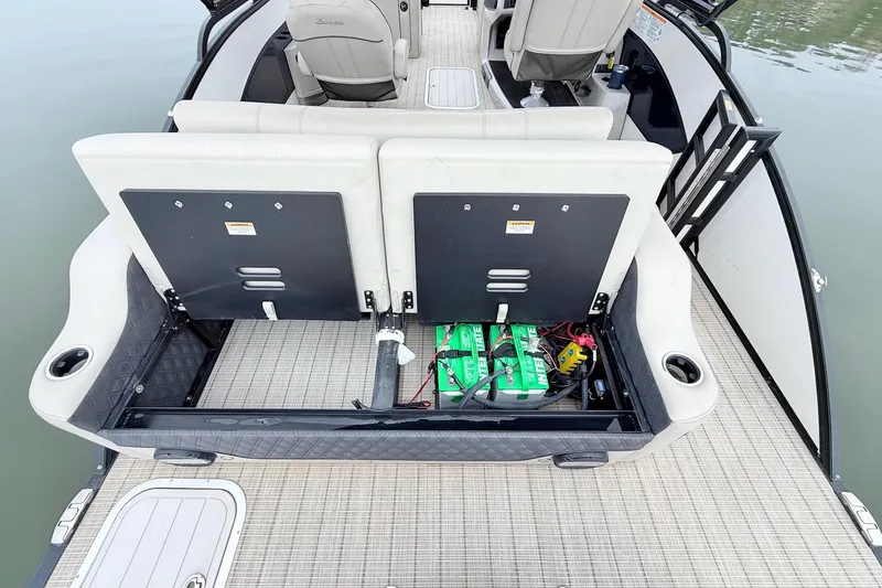 Slide: The Image of 2020 Barletta L23UC boat interior with open storage compartment and visible batteries. - 25