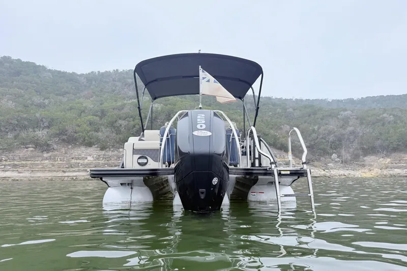 Slide: The Image of 2020 Barletta L23UC pontoon boat on a lake with scenic background. - 4
