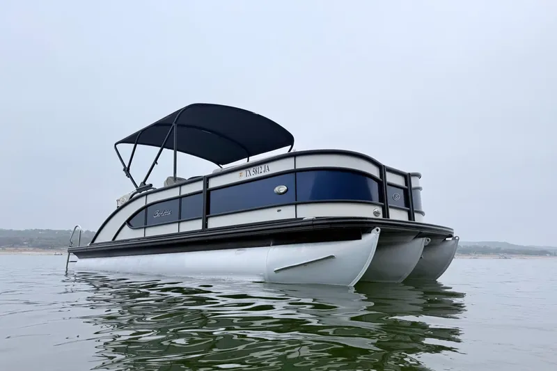 Slide: The Image of 2020 Barletta L23UC pontoon boat on calm water with canopy. - 7