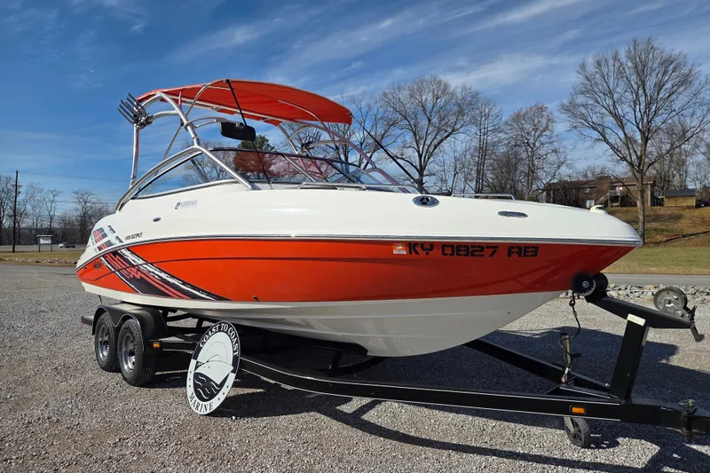 Slide: The Image of 2008 Yamaha Boats AR230 HO on trailer, red and white design, parked outdoors. - 1