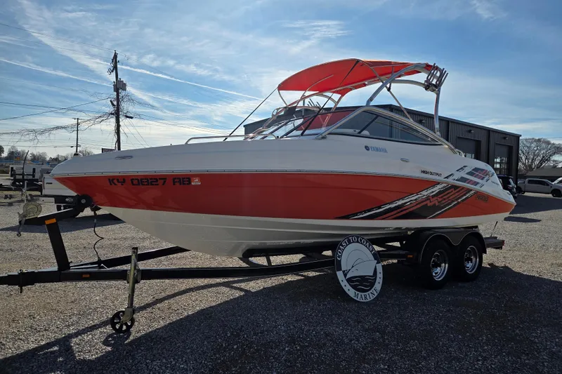 Slide: The Image of 2008 Yamaha Boats AR230 HO with red and white design on a trailer. - 2