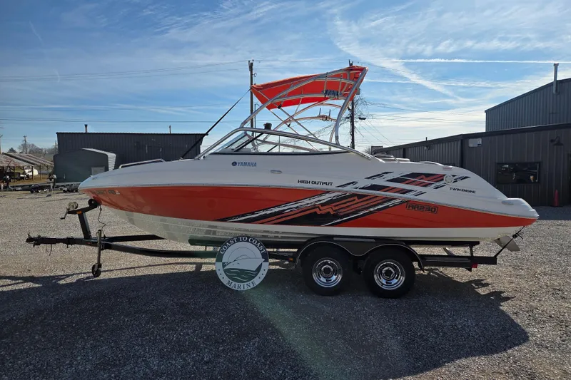 Slide: The Image of 2008 Yamaha Boats AR230 HO on trailer, featuring vibrant orange and white design. - 3