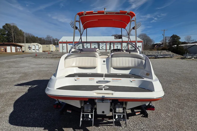 Slide: The Image of 2008 Yamaha Boats AR230 HO with red canopy, parked on gravel lot. - 5