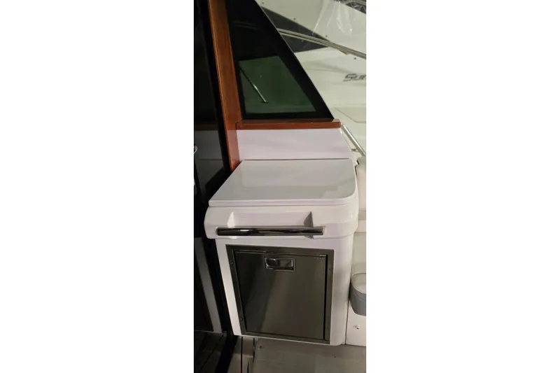 Slide: The Image of 2024 Regal 42 Fly yacht interior with elegant seating and staircase in a marina setting. - 16