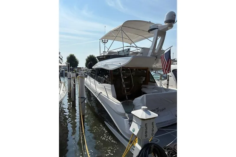 Slide: The Image of 2024 Regal 42 Fly yacht docked, showcasing sleek design and modern features. - 2